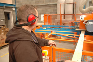 Showing factory safety features such as machine guards and ear protectors